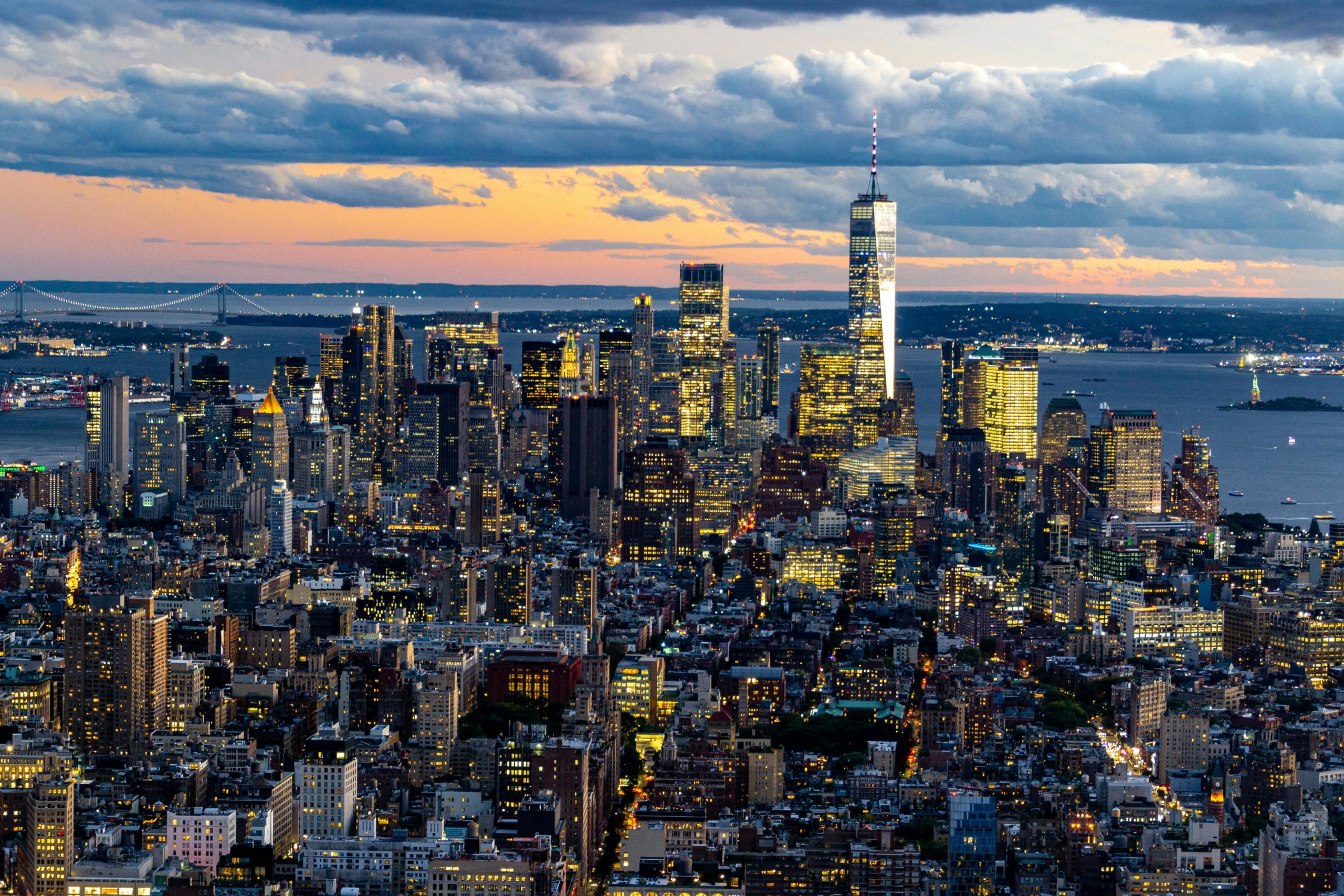 A breathtaking aerial cityscape of New York City at sunset, showcasing iconic skyscrapers and vibrant urban life.
