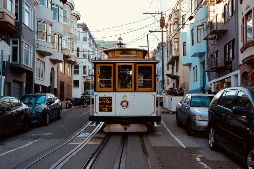 Iconic San Francisco streetcar on a bustling city street.