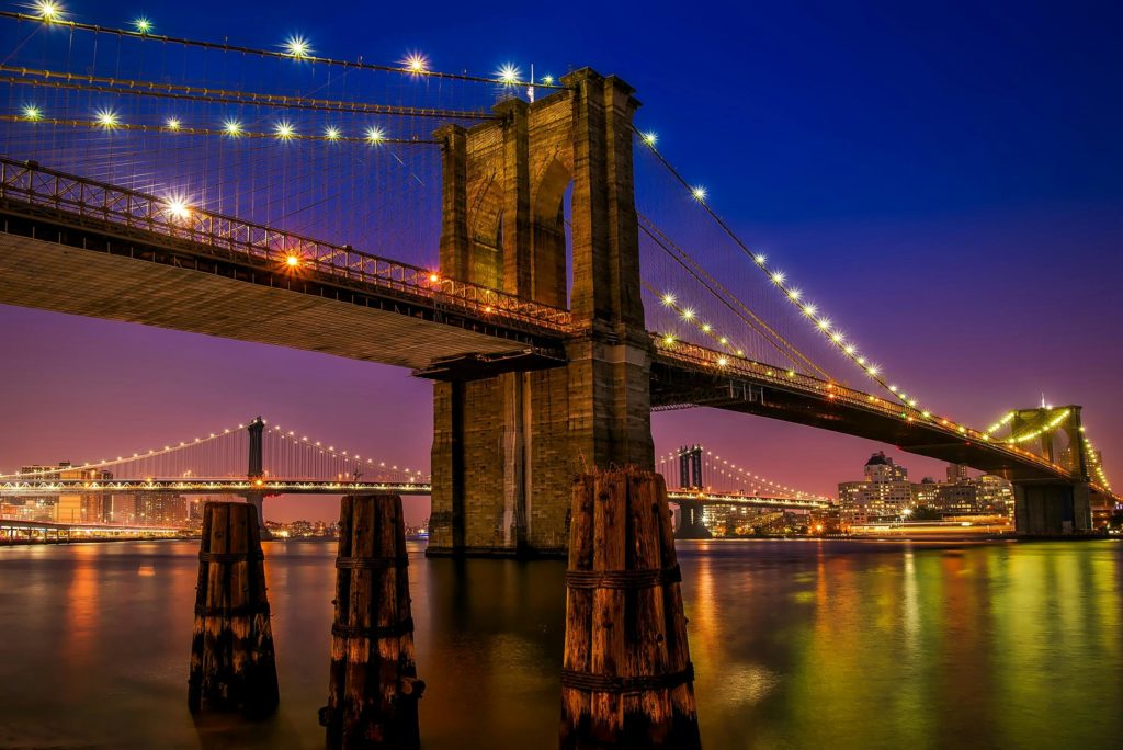 Stunning evening view of the illuminated Brooklyn Bridge in New York City.