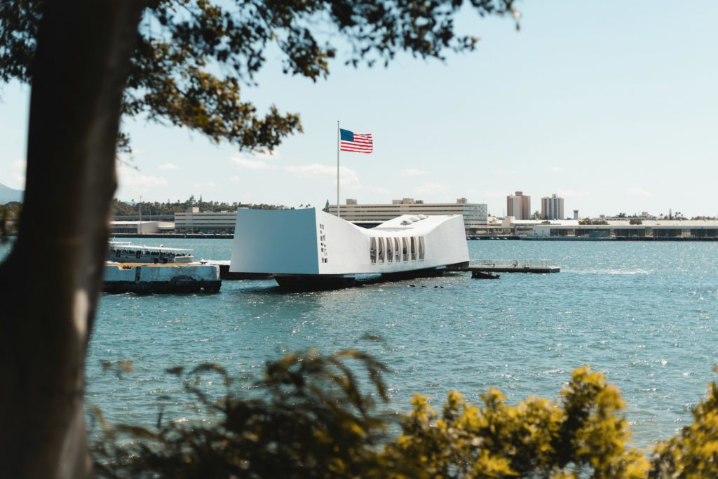 The USS Arizona Memorial over Pearl Harbor waters, a tribute to WWII history in Honolulu, Hawaii.