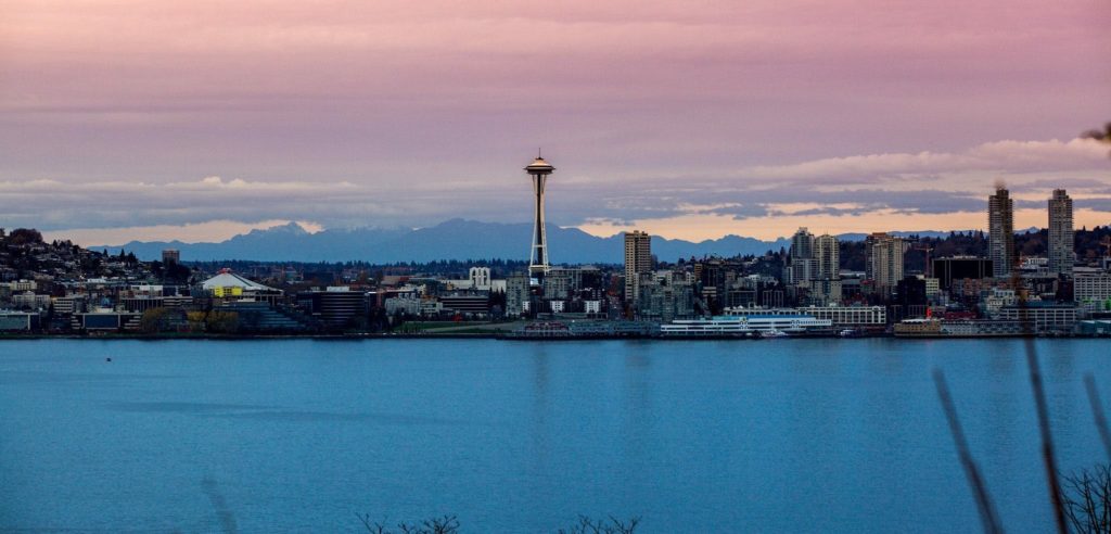 Stunning view of Seattle skyline featuring the Space Needle during sunset over the waterfront.